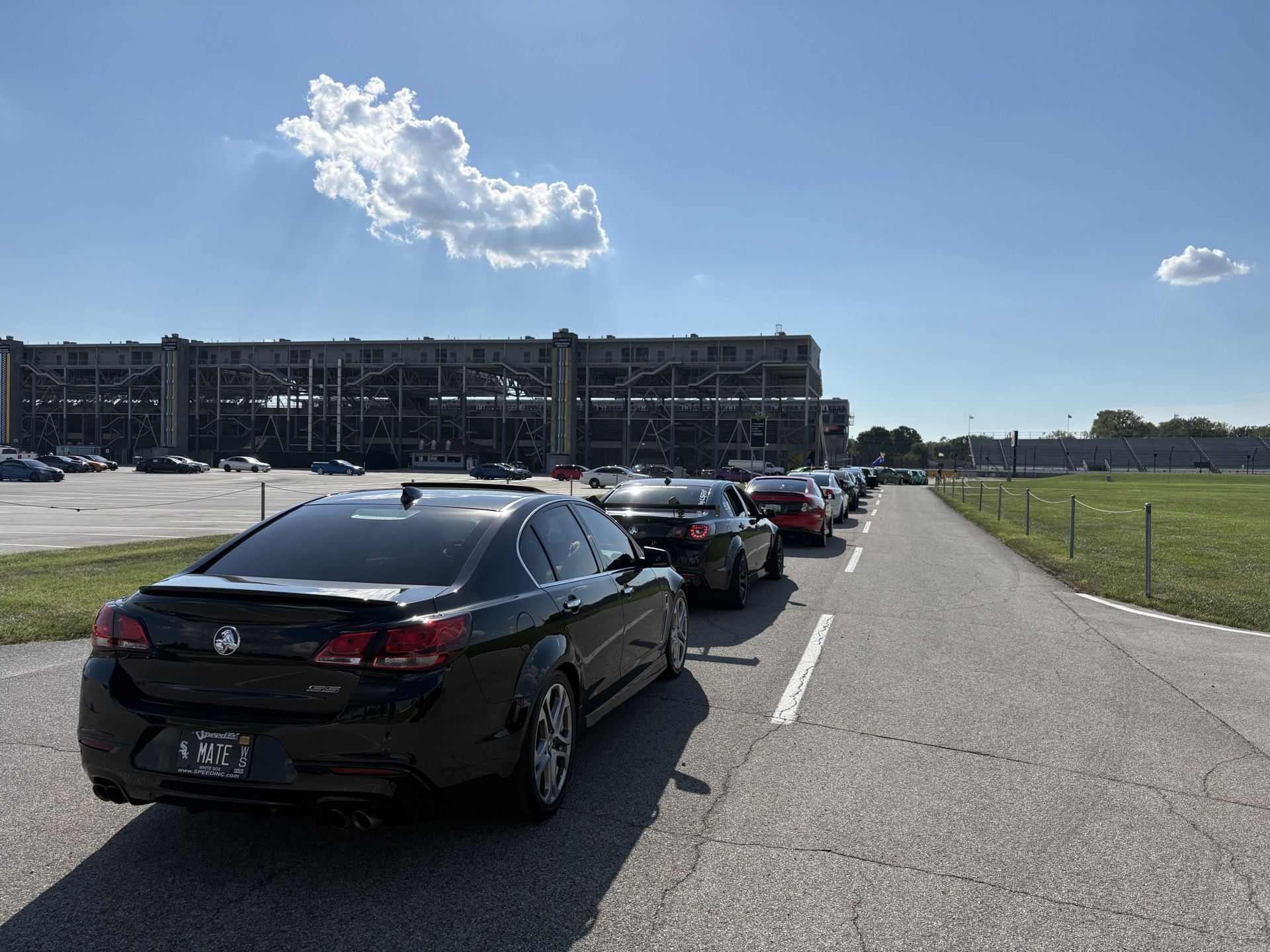 Line of Holdens driving down the access road at Indianapolis Motor Speedway
