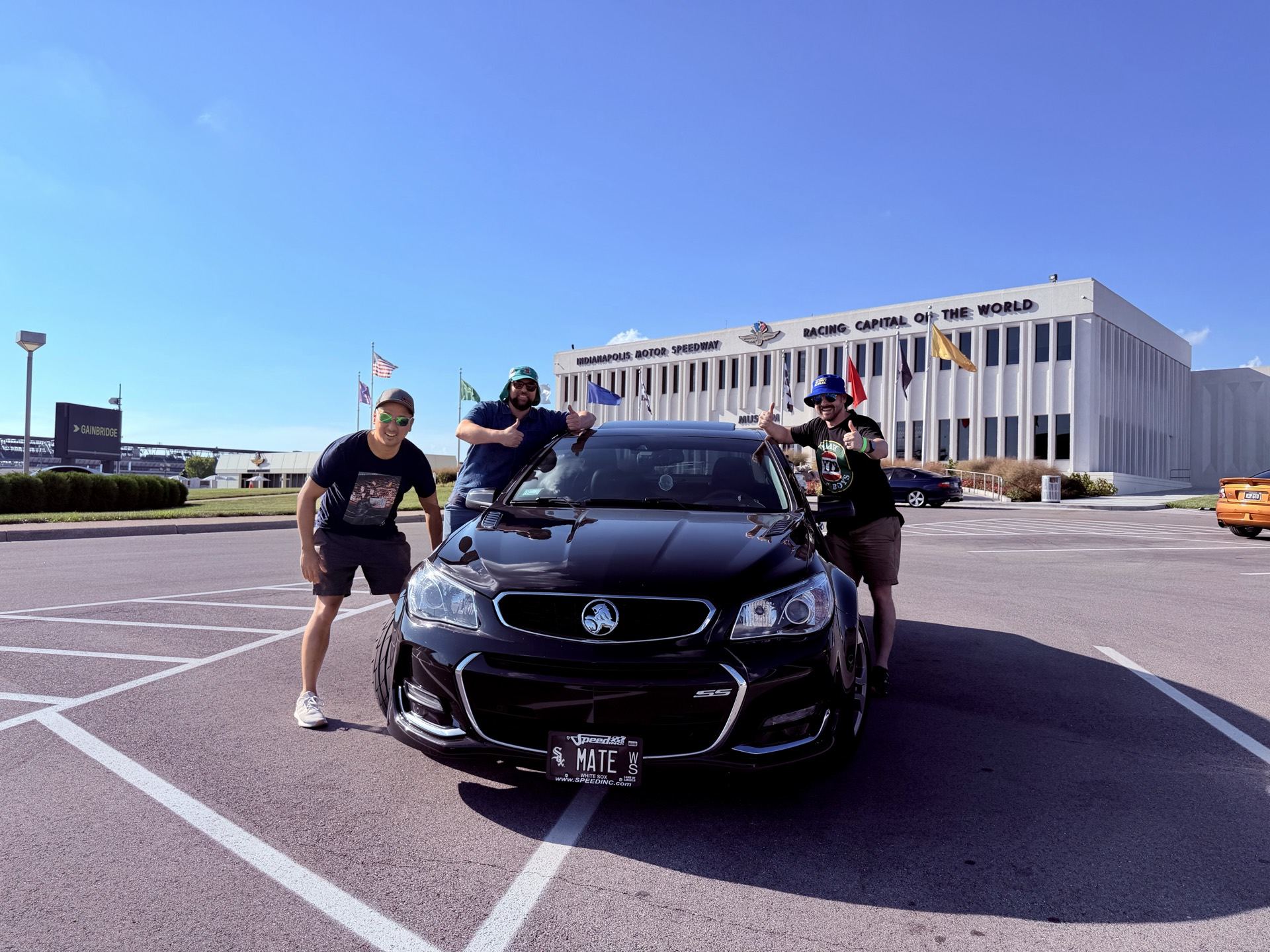 Friends posing with the Chevy SS in front of the IMS administration building