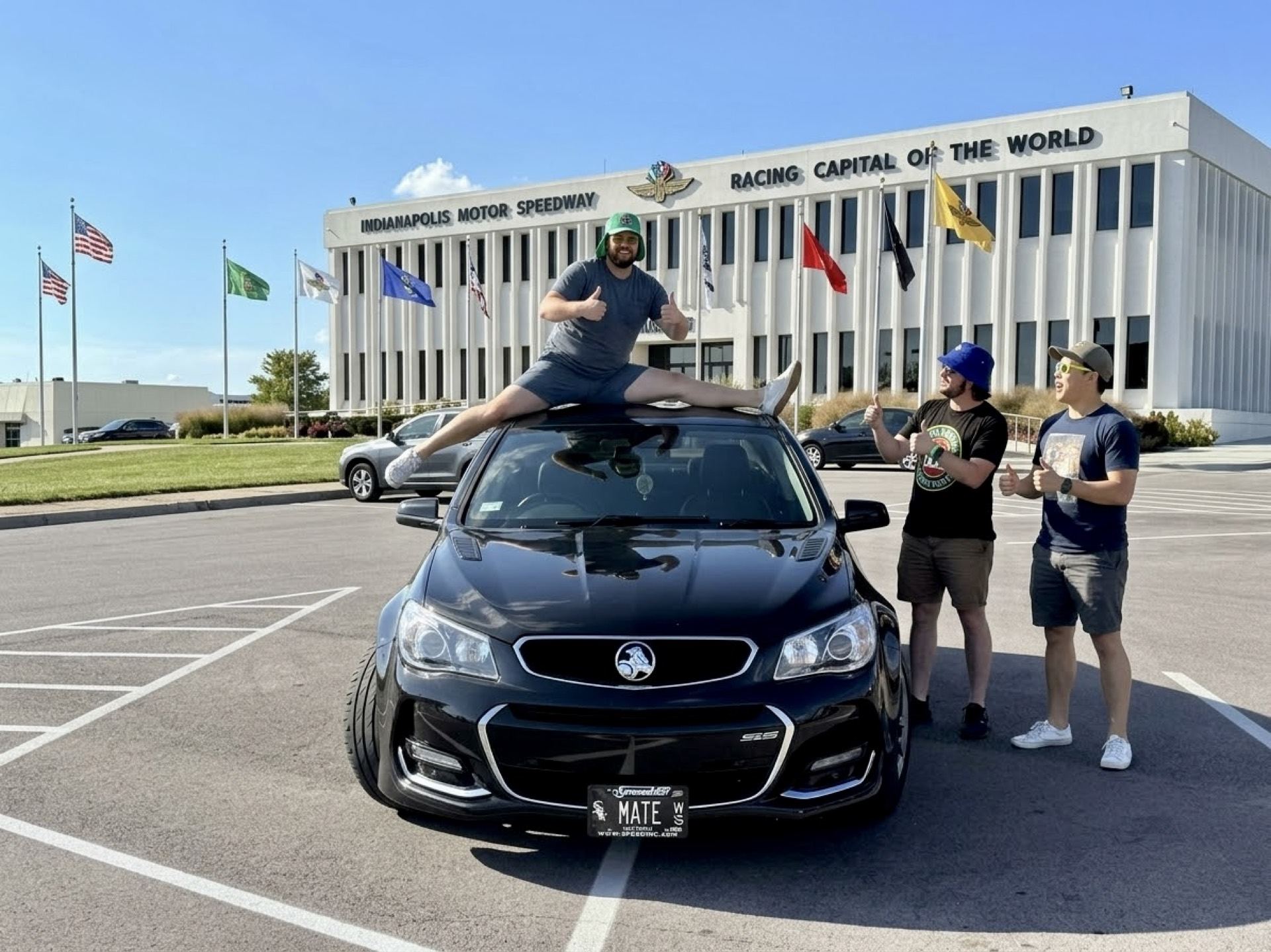 A friend standing on the roof of the SS in front of the Racing Capital of the World sign